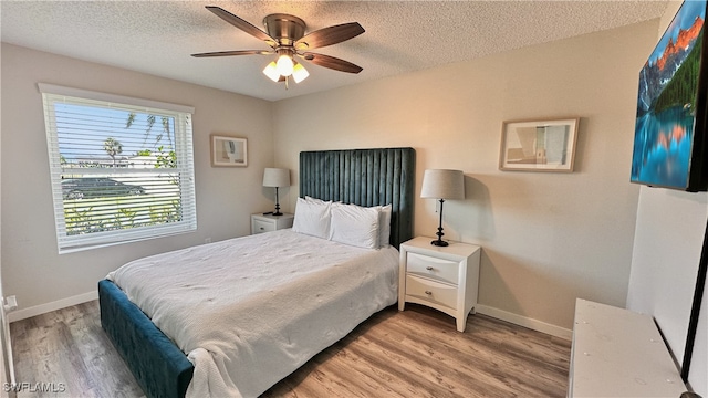 bedroom featuring a textured ceiling, hardwood / wood-style flooring, and ceiling fan