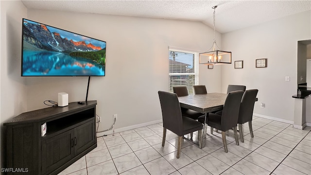 dining space featuring a chandelier, light tile patterned floors, a textured ceiling, and vaulted ceiling