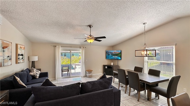 living room featuring vaulted ceiling, light tile patterned flooring, and a textured ceiling