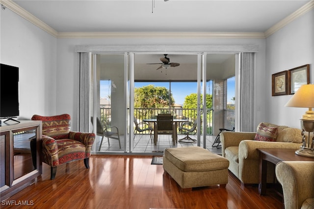 living area with crown molding, dark wood-type flooring, and ceiling fan