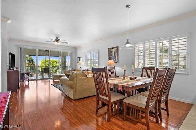 14819 Laguna Dr Unit 203, Fort Myers, FL 33908 - dining area with baseboards, crown molding, wood finished floors, and a ceiling fan