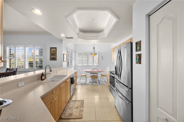 kitchen with sink, light tile patterned floors, appliances with stainless steel finishes, ornamental molding, and light brown cabinets