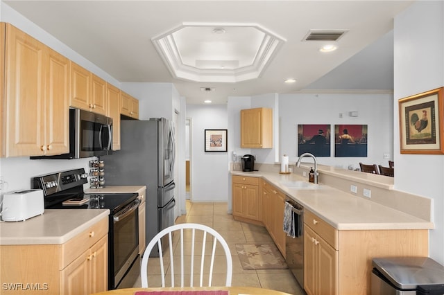 kitchen with light brown cabinetry, sink, appliances with stainless steel finishes, kitchen peninsula, and a raised ceiling