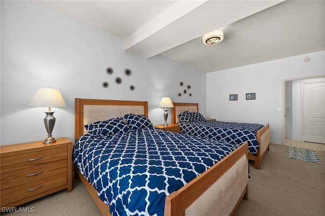 carpeted bedroom with beamed ceiling