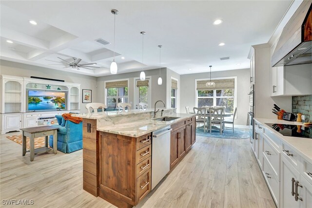 kitchen with a large island, dishwasher, hanging light fixtures, black electric stovetop, and white cabinets