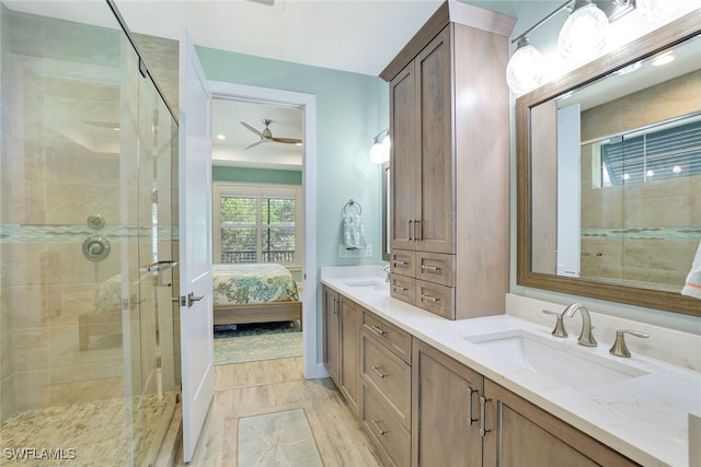 bathroom with vanity, hardwood / wood-style floors, ceiling fan, and walk in shower