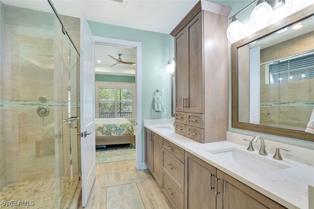 bathroom featuring vanity, an enclosed shower, and ceiling fan