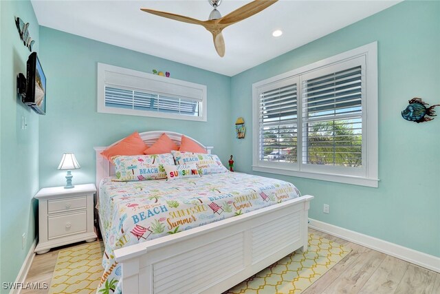 bedroom with ceiling fan and light hardwood / wood-style flooring