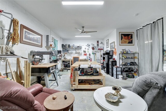 living room with a workshop area and ceiling fan