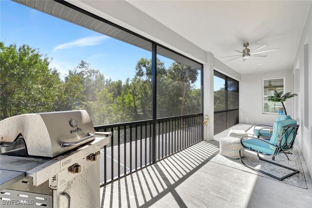 sunroom / solarium featuring ceiling fan