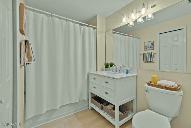 full bathroom with vanity, hardwood / wood-style floors, shower / bathtub combination with curtain, and toilet