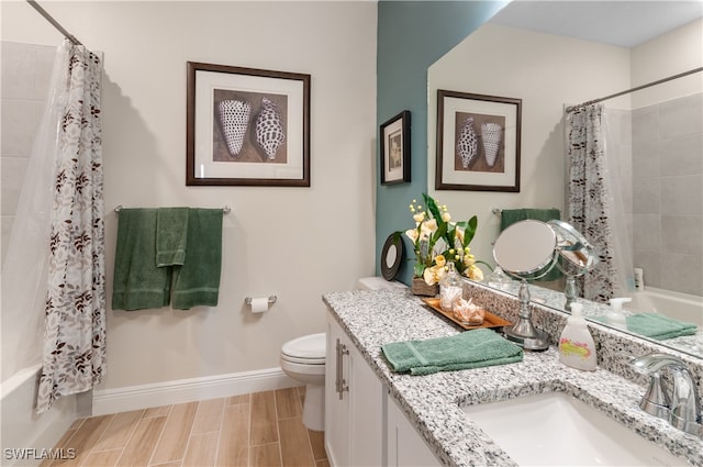 full bathroom featuring shower / bath combo with shower curtain, vanity, and toilet