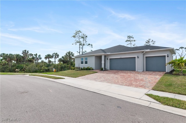 view of front of property featuring a front lawn and a garage