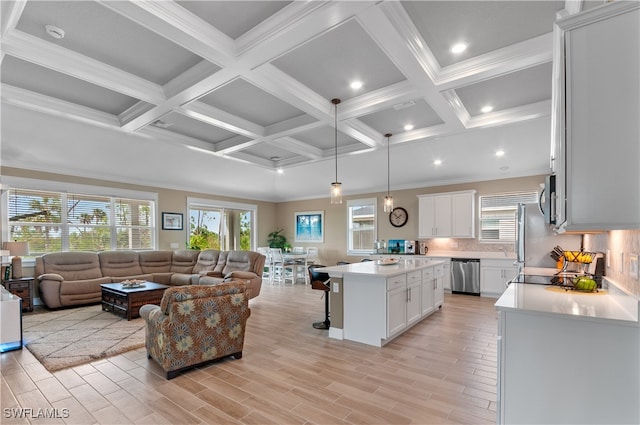 living room with beamed ceiling, light hardwood / wood-style floors, ornamental molding, and coffered ceiling