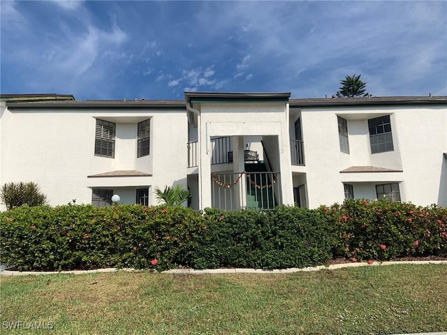 17160 Hawks Nest Unit 9, Fort Myers, FL 33908 - view of front of house featuring stucco siding and a front lawn