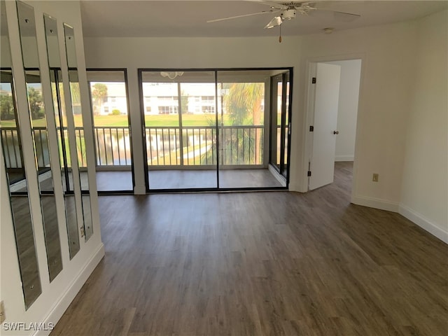 spare room featuring ceiling fan and dark wood-type flooring