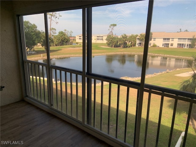 unfurnished sunroom featuring a water view