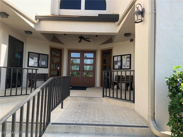 doorway to property with french doors, a porch, and ceiling fan