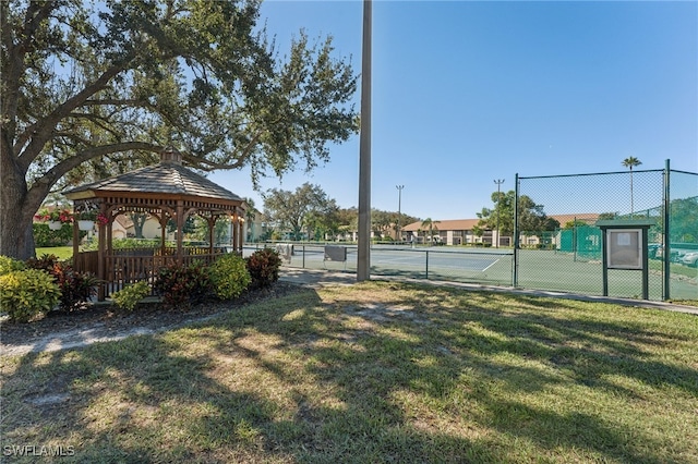 view of sport court with a gazebo and a yard