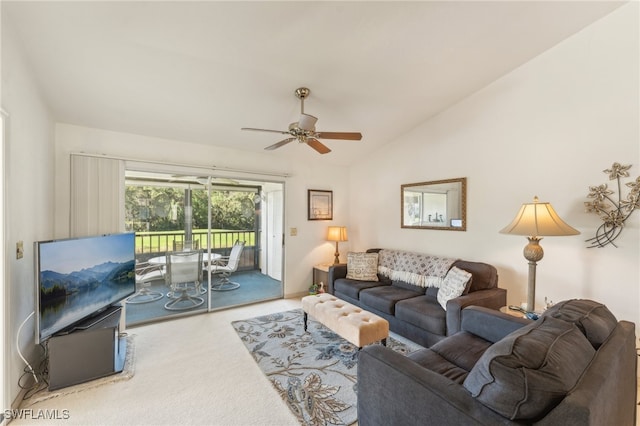 carpeted living room with ceiling fan and lofted ceiling