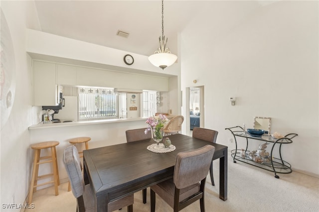 dining area featuring light colored carpet