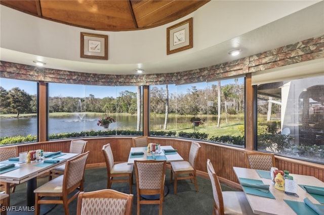 sunroom / solarium with plenty of natural light and a water view