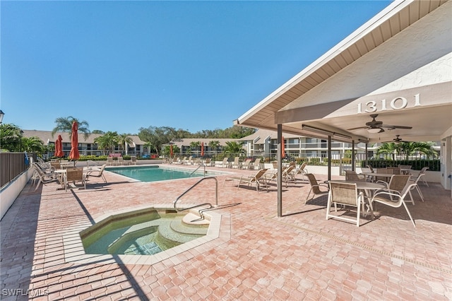 view of pool featuring a patio area, ceiling fan, and a community hot tub