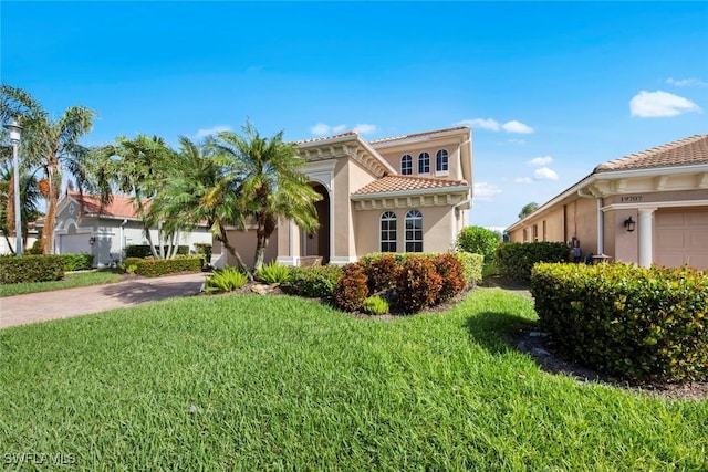 mediterranean / spanish home featuring a front lawn