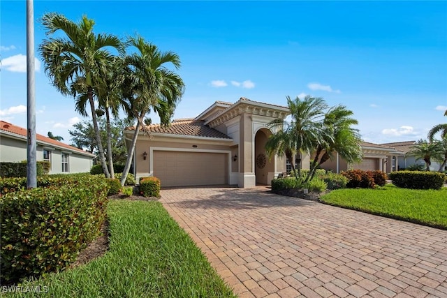 view of front of property with a garage and a front lawn