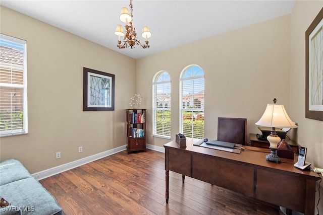 office featuring a chandelier, plenty of natural light, and dark wood-type flooring