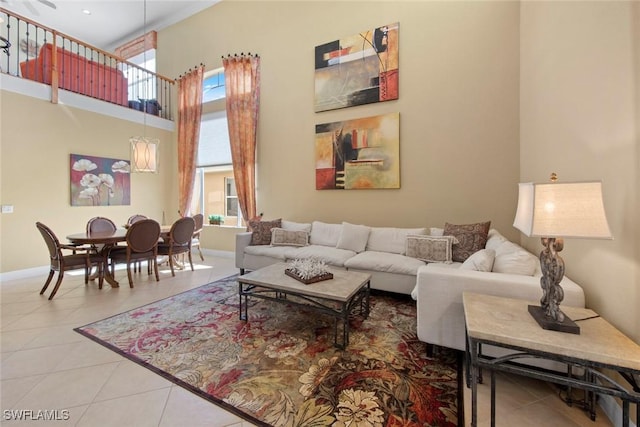 tiled living room featuring plenty of natural light and a high ceiling