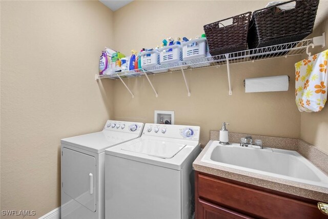 laundry room with separate washer and dryer and sink