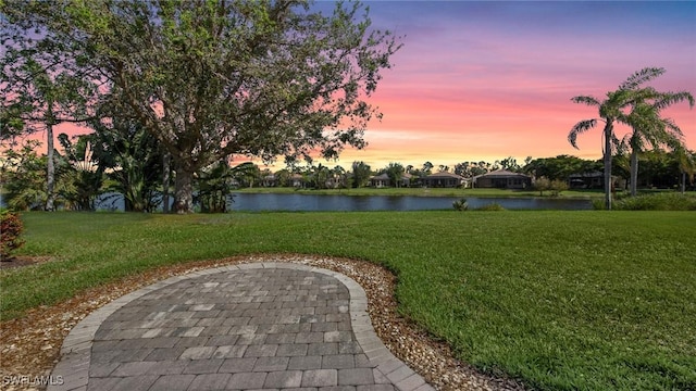 exterior space with a water view and a patio