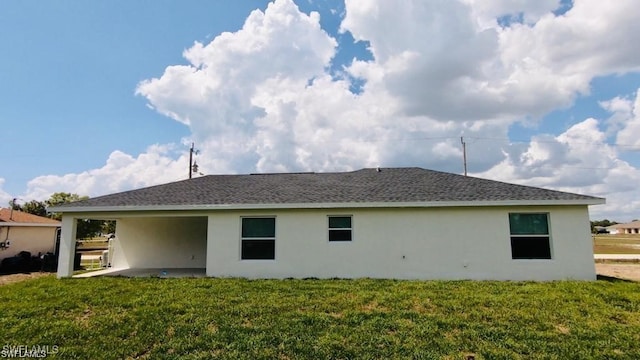 rear view of property featuring a yard and a patio