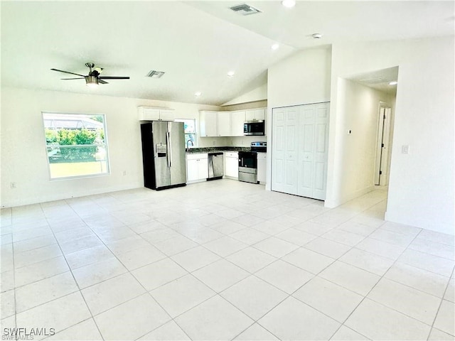 unfurnished living room featuring light tile patterned floors, vaulted ceiling, and ceiling fan