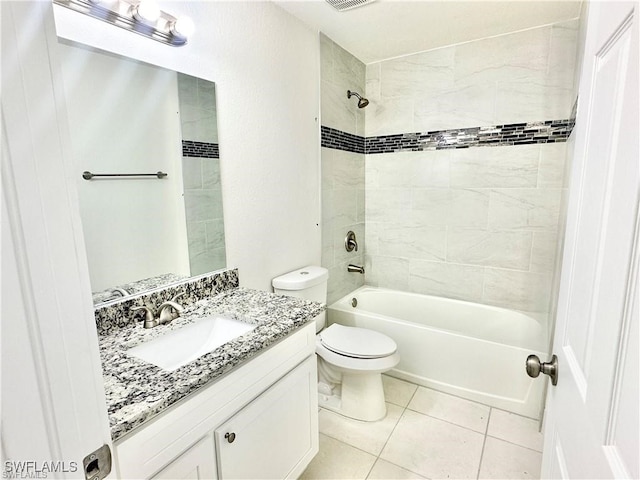 full bathroom featuring tile patterned floors, toilet, vanity, and tiled shower / bath