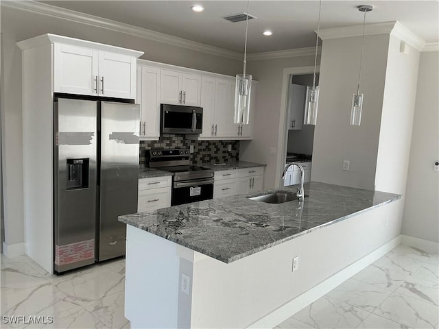 kitchen with white cabinets, decorative light fixtures, sink, and appliances with stainless steel finishes