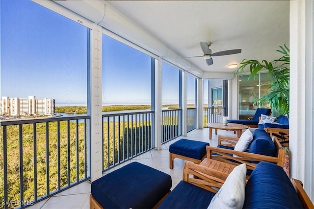 sunroom / solarium with a water view and ceiling fan