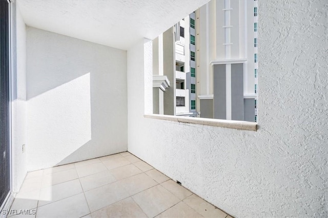 exterior space featuring tile patterned floors and a textured ceiling