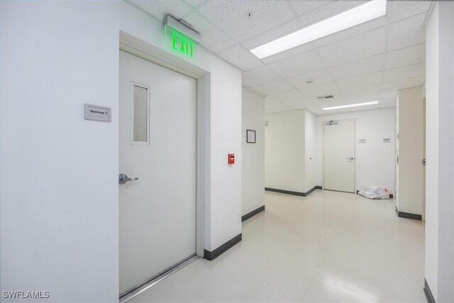 hallway featuring a drop ceiling