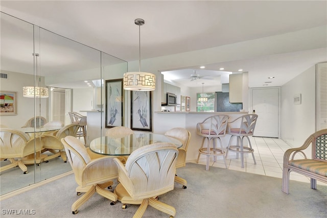 dining area with ceiling fan and light tile patterned floors