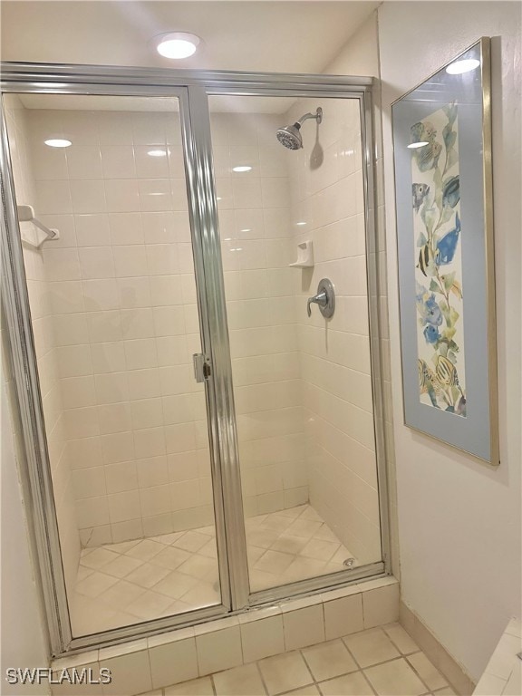 bathroom featuring tile patterned flooring and a shower with shower door