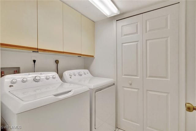 laundry area featuring cabinets and washing machine and clothes dryer