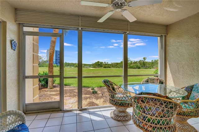 sunroom / solarium featuring ceiling fan and a healthy amount of sunlight