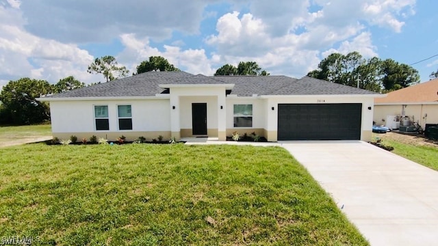 view of front facade with a garage and a front lawn