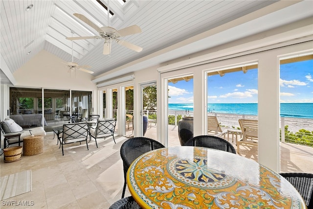 sunroom featuring lofted ceiling, a water view, ceiling fan, a beach view, and wood ceiling