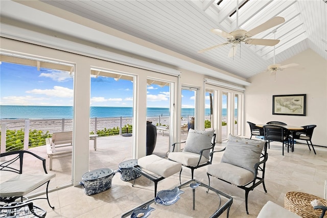 sunroom / solarium with wooden ceiling, a water view, a view of the beach, vaulted ceiling, and ceiling fan