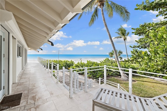 balcony with a beach view and a water view