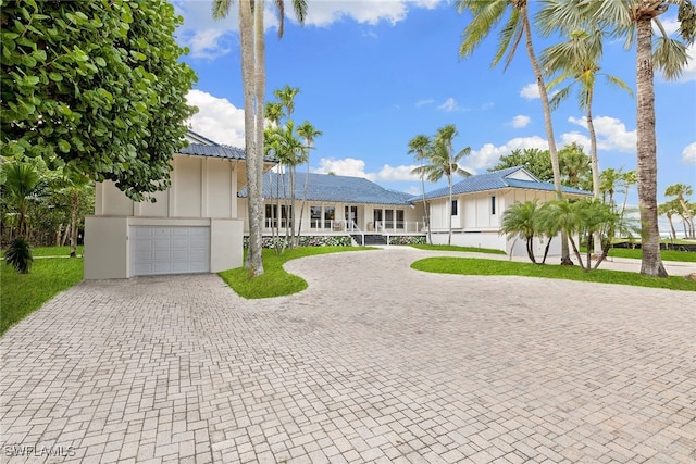 view of front of home featuring a porch and a garage