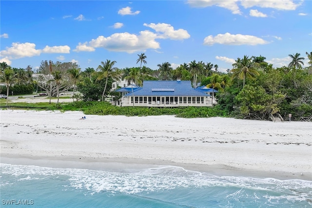 exterior space featuring a water view and a view of the beach